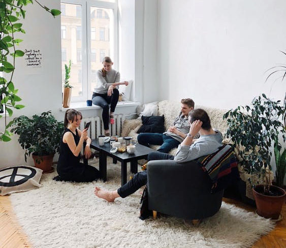 Apartment Management group of people lounging in the living room of an apartment